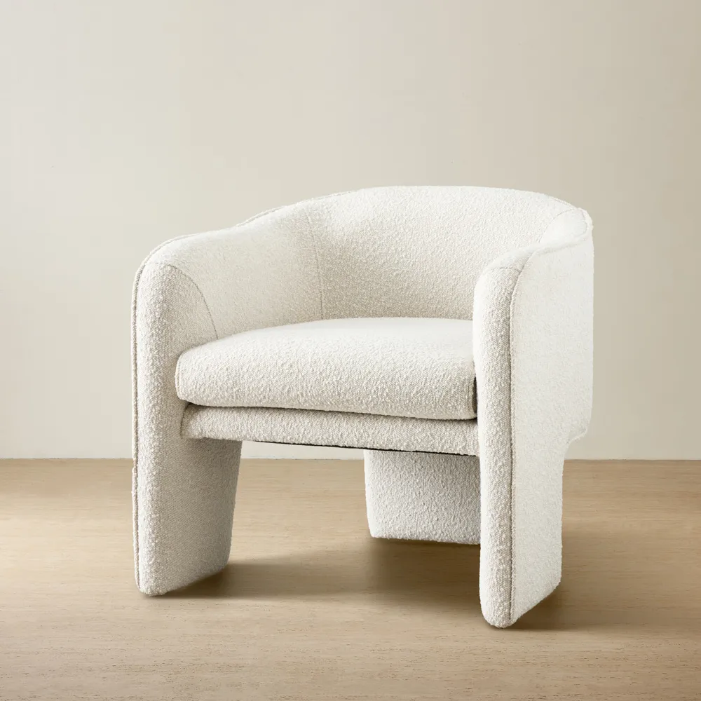 Cream boucle armchair featuring a three-section design with matching cream boucle legs, comfortable cushioned seats, and a supportive backrest.