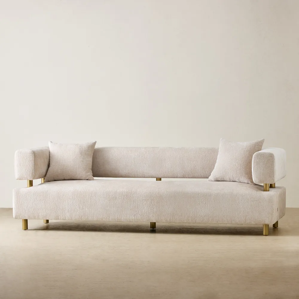 3-seater powder white chenille fabric sofa with brushed gold stainless steel legs, featuring an equal backrest height to the armrests and includes two cushions.
